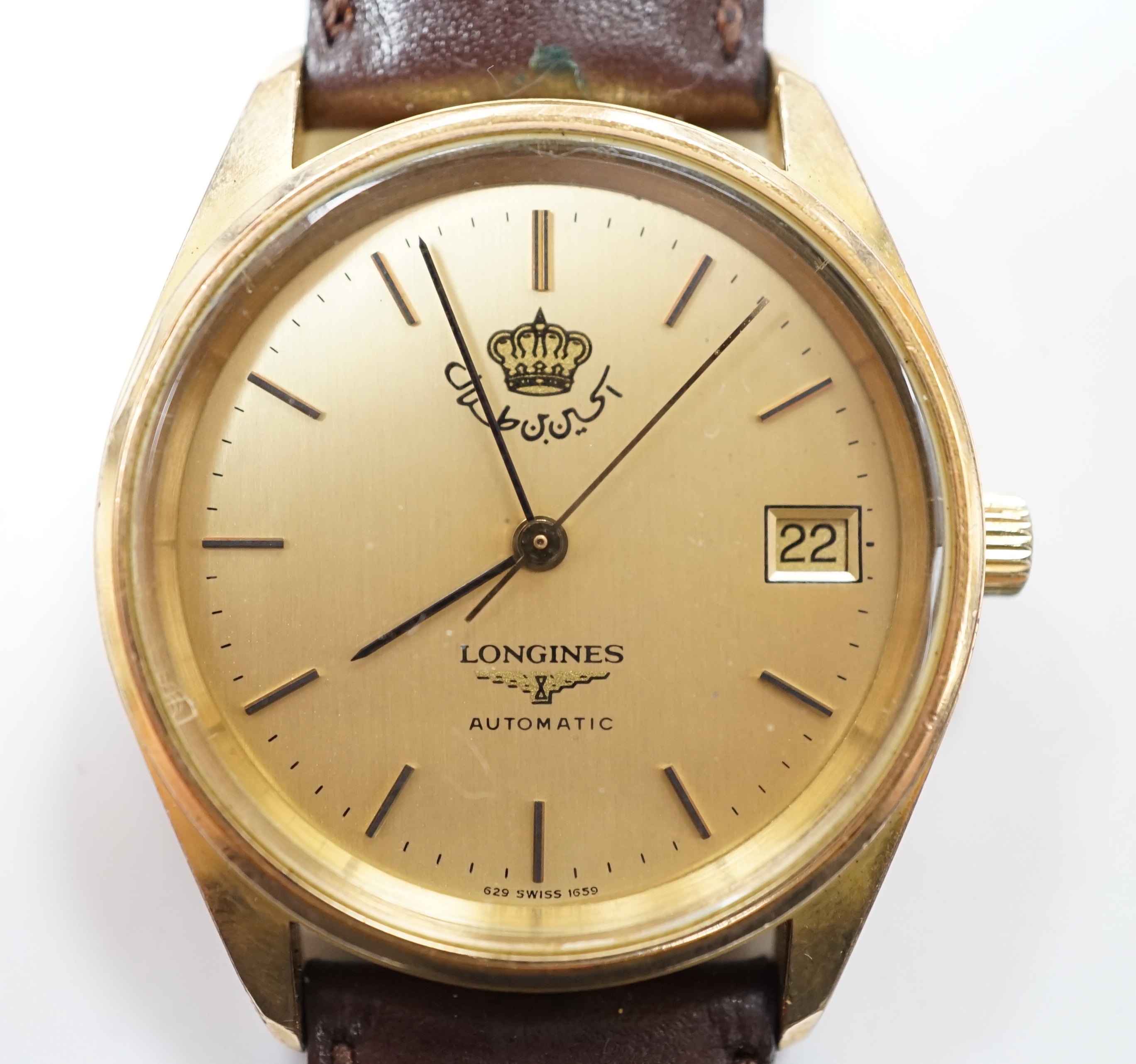 A gentleman's steel and gold plated Longines Automatic wrist watch, the dial with King Hussein of Jordan crown, on associated leather strap, with Longines box.